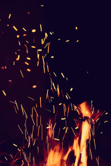 Fototapeta na wymiar Night bonfire with sparks background. Vertical composition