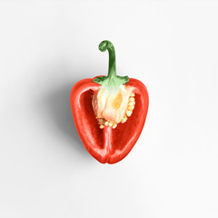 Sweet red pepper in a top view Half of fresh red pepper is lying on a white background Photo template with copy space