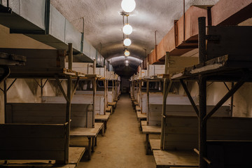 Wooden double-decker beds inside old abandoned soviet bomb shelter 