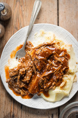Pulled beef in barbecue sauce with mashed potatoes & crisp fried onions