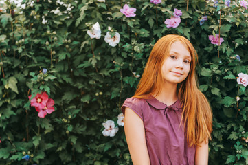 Outdoor portrait of beautiful red-haired girl