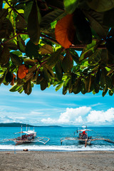 Sand beaches, travel boats and pristine waters at Mindoro island, Philippines