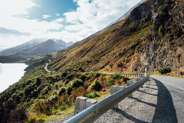 Long winding road leading to a snow capped mountain in New Zealand