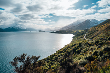Long winding road leading to a snow capped mountain in New Zealand