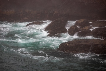 water color pacific ocean waters beating on the rocks at yaquina head outstanding natural area in Newport Central Oregon Pacific Northwest USA