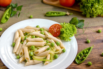 Penne pasta with green peas, zucchini noodle  and herbs