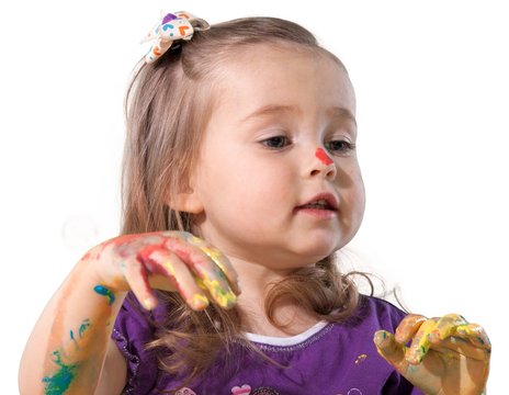 Cute baby girl with colored paint on hands isolated on white