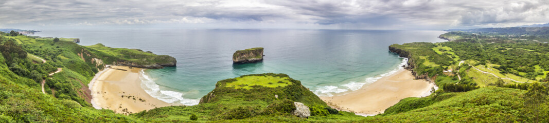 Llanes at North of Spain at Asturias region is an amazing place for enjoying the outdoors with amazing wild and green beaches like this panoramic view of Ballota beach at east of Llanes town, Spain