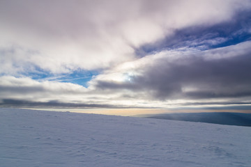 Fototapeta na wymiar Winter alpine scenery with fresh snow, mist, and beautiful evening light