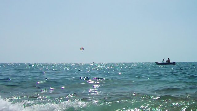 Boat on the coast and parasailing