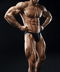 Bodybuilder man with perfect abs, shoulders,biceps, triceps and chest.