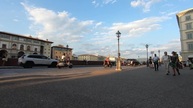 Clouds and pedestrians Hyperlapse from a busy street on the Arno river