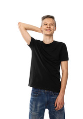 young teenager in black t-shirt and jeans smiles