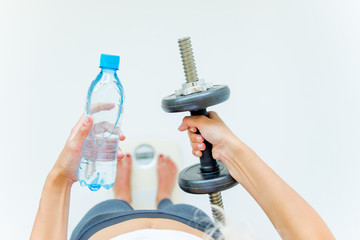 Fit woman measuring waist with measuring tape
