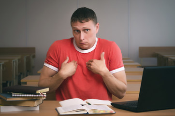 The student is sitting at the table and is looking for excuses for not being ready for the lesson.