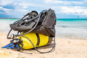 Equipment of a scuba diver, an oxygen balloon lies on the beach. Diving, equipment, fins, balloons,...