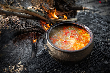 Cooking dinner on firewood stove. Cooking using firewood is an survival skill needed when going to...