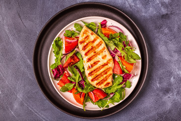 Chicken breast with fresh salad.