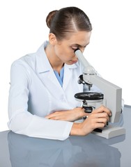 Young Female Scientist Working with Microscope on white