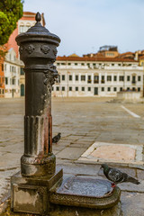 Antique water pump in a courtyard in Venice Italy