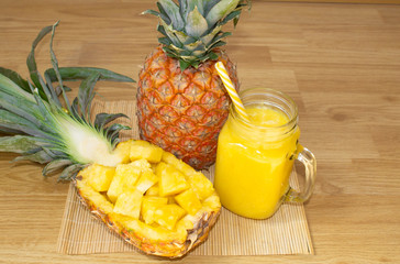 Still life. Pineapple juice, smoothies with fresh pineapple for breakfast in the morning on a wooden table. Detox. For health and for losing weight.