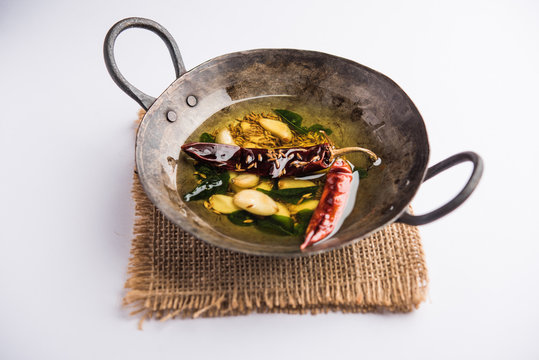 chaunk / Tadka / Tempering spices also known as baghaara, fodni, tarka or vaghaar. Typically prepared in Iron Karahi/kadhai. selective focus