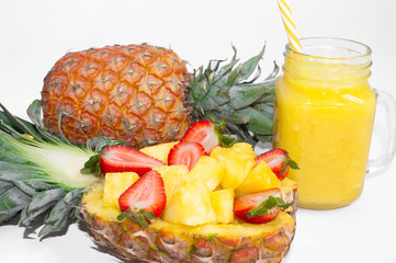 Still life. Pineapple juice, cocktails with fresh pineapple and fresh strawberries for breakfast in the morning, on a white background. Close-up. Detox. For health and for weight loss.
