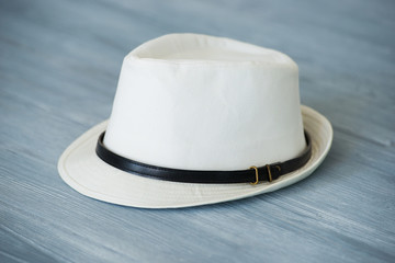 Vintage straw hat fashion for man, against a background of gray wooden boards