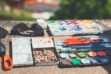 accessories for drawing in the park, paints, pencils. close up.