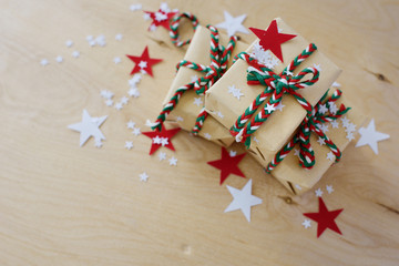 Christmas gifts in Kraft to packing on a wooden background