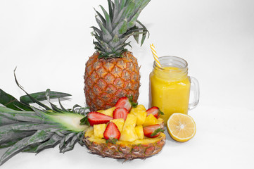 Still life. Pineapple juice, cocktails with fresh pineapple and fresh strawberries for breakfast in the morning, on a white background. Close-up. Detox. For health and for weight loss.