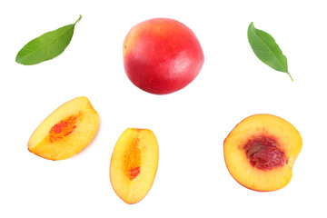 Nectarine with green leaf and slices isolated on white background. top view