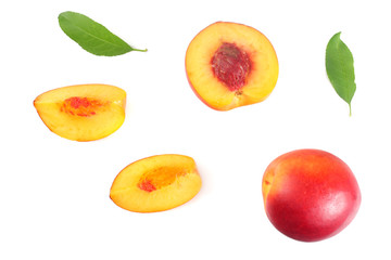 Nectarine with green leaf and slices isolated on white background. top view