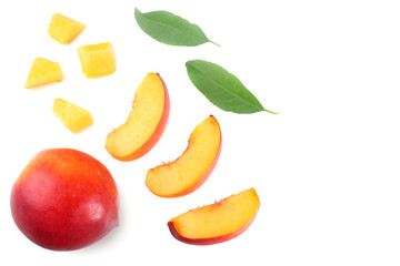 Nectarine with green leaf and slices isolated on white background. top view