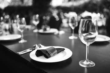 Sparkling glassware stands on long table prepared for wedding dinner.