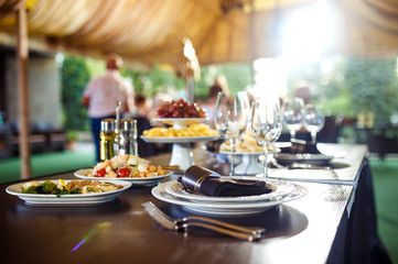Sparkling glassware stands on long table prepared for wedding dinner