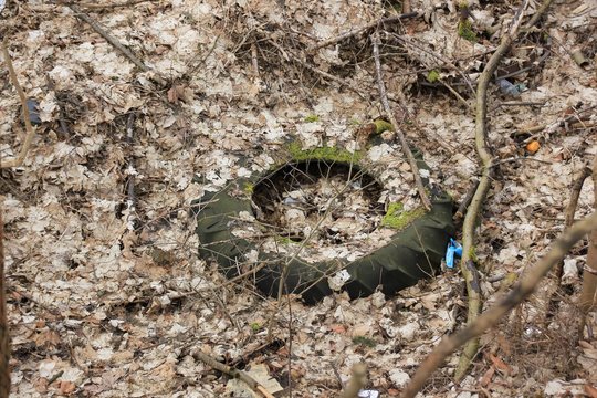 Tire carelessly thrown away in the nature /Carelessly discarded items pollute the environment and cause problems for all humanity