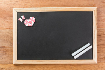 heart shape made from white pink straw decorate rectangle blank slate chalk board with wooden frame...
