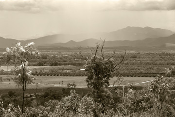 Obraz premium Sepia tinted storm over hills on the Atherton Tableland in Queensland, Australia