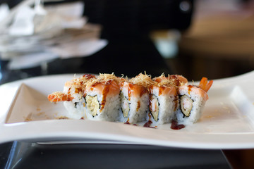 close up of sushi rolls with shrimp and salmon
