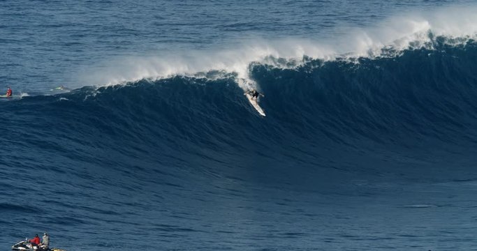 Male big wave surfer on a large wave during high surf conditions