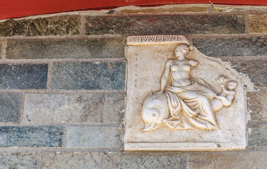 motifs from Greek mythology built into the wall 