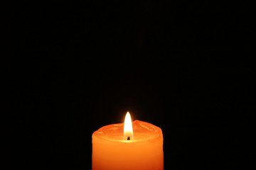 One Orange Color Candle Shining in the Darkness, with Free Space for Text or Design 