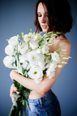 Beautiful girl with a bouquet flowers.