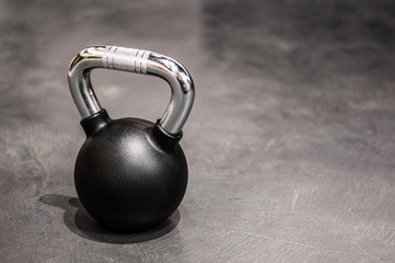 Fototapeta na wymiar health and sport lifestyle concept, steel athletic kettlebell weight in a black shell