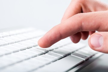 Person pressing key on a keyboard
