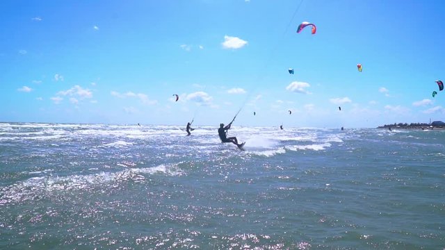 Slow motion, A man on kitesurf jumps over the camera