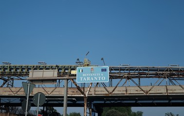 Signage "Welcome to Taranto", coastal city in Southern Italy, important commercial and military port with well-developed steel and iron foundries and oil refineries