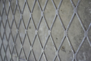 Naklejka premium Metal mesh on cement wall background