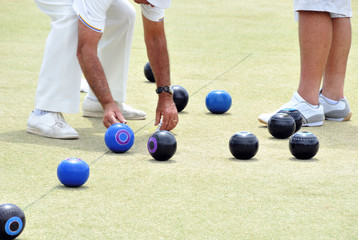 People bowling on a bowling green